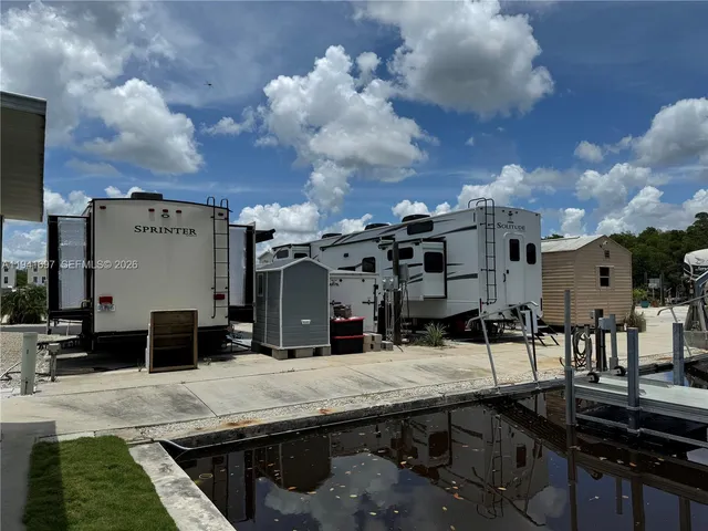 a view of a patio with table and chairs with wooden floor and fence