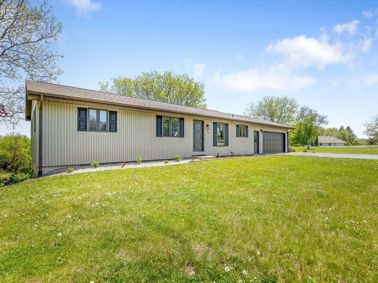 136 Lake Summerset Road Lake Summerset, IL 61019 - Photo 2 of 47 a front view of house with yard and trees in the background