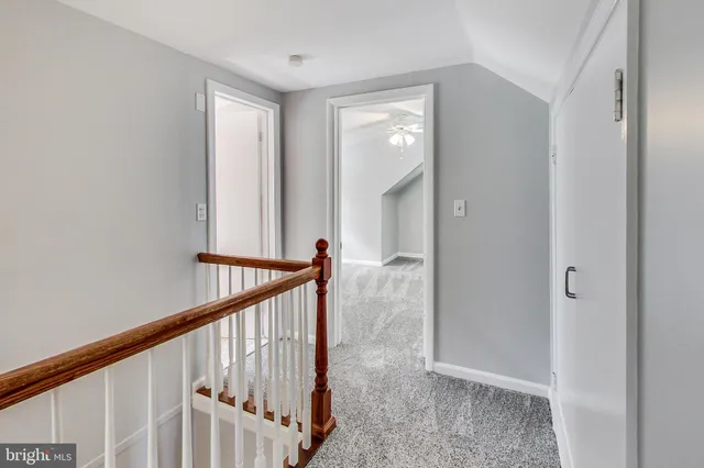 a view of a hallway with wooden floor and entryway
