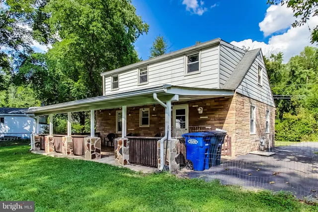a view of a house with backyard porch and sitting area