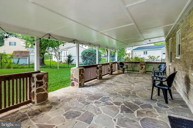 a view of a porch with chairs and backyard