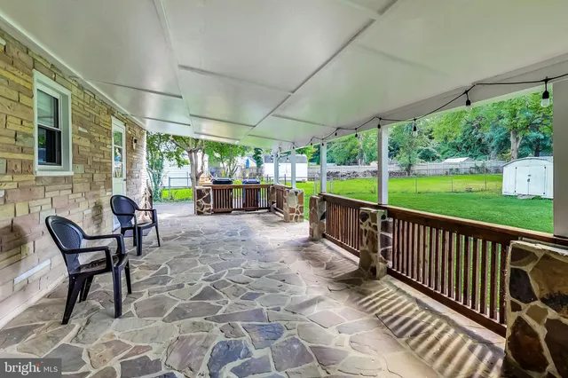 a view of a porch with furniture and garden