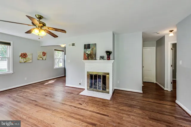 a view of a livingroom with a fireplace and window