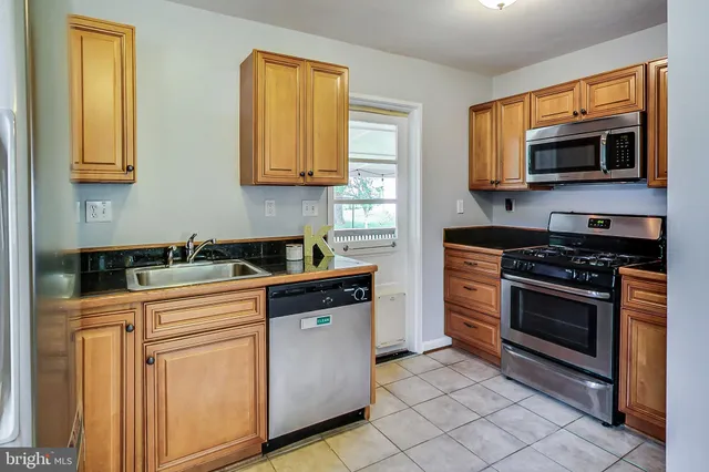 a kitchen with stainless steel appliances a stove cabinets and a sink