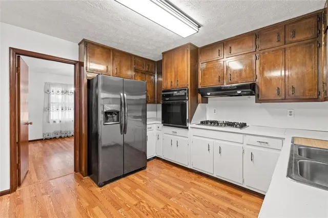 a view of a house with a yard patio and fire pit