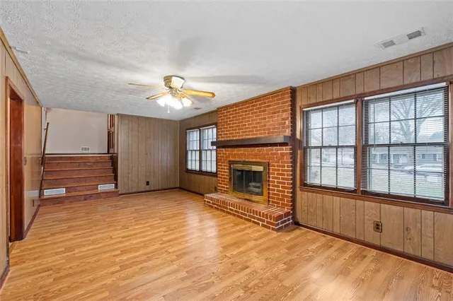 a front view of a house with a yard covered with snow