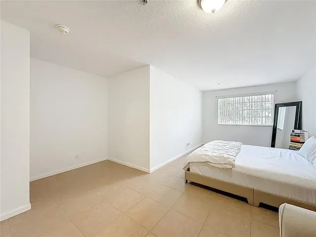 a bedroom with a bed and a mirror