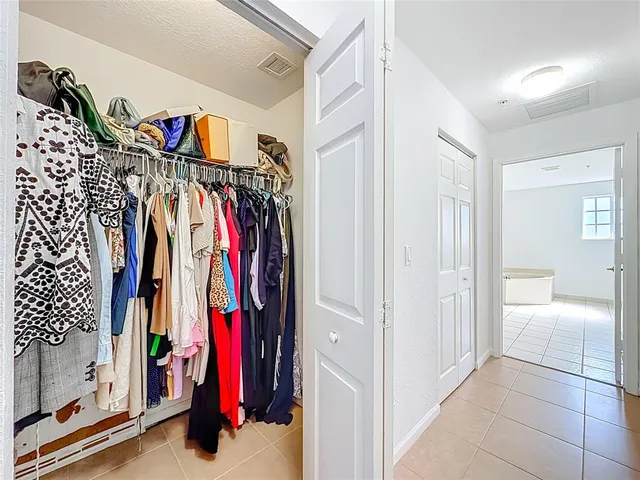 a spacious bathroom with a granite countertop sink mirror and bathtub