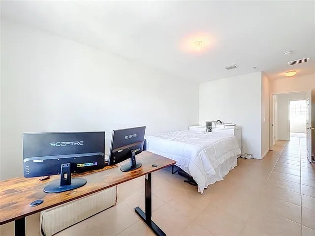 a spacious bedroom with a bed and window