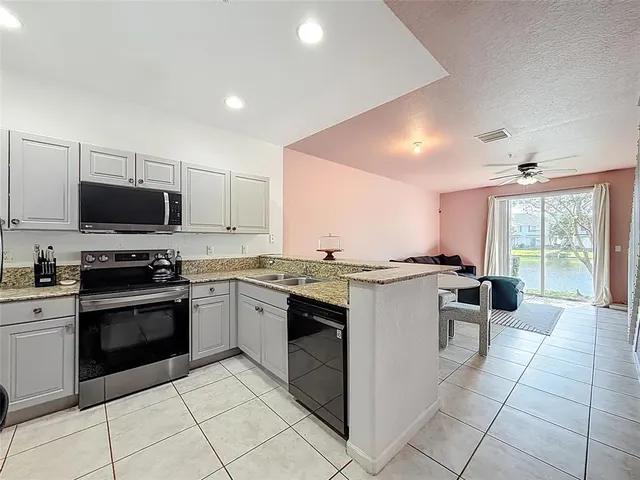 a kitchen with a sink and stove top oven