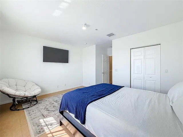 a spacious bedroom with a bed and window