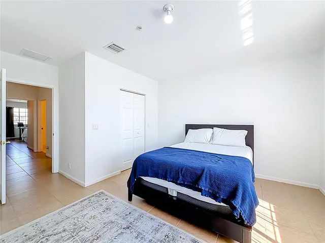 a spacious bedroom with a bed and a window