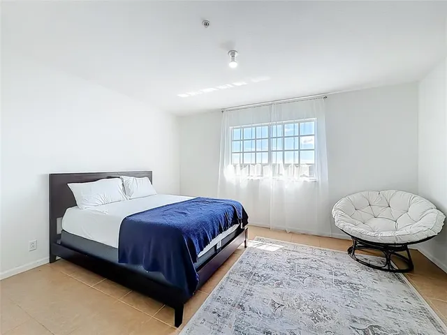 a view of a bedroom with washer and dryer