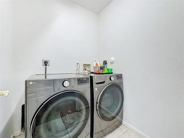 a view of a hallway with wooden table and chairs