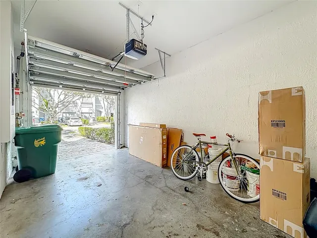 an aerial view of residential houses with outdoor space and lake view
