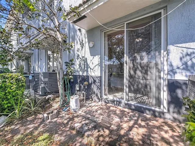 a front view of a building with cars parked