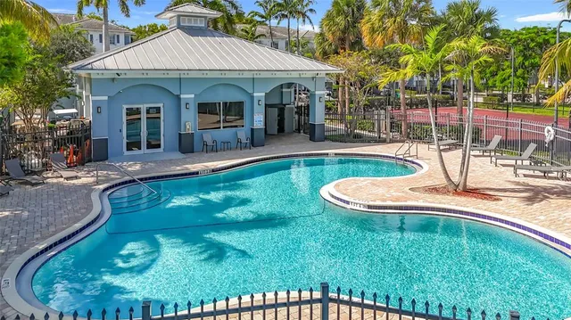 an aerial view of a house with a yard and swimming pool
