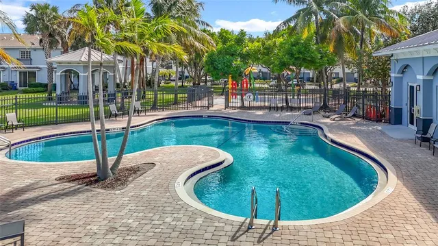 a view of a swimming pool with a patio and yard