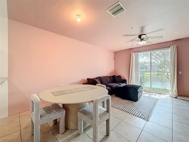 a view of a dining room with furniture and a chandelier