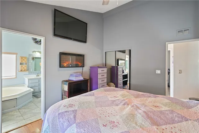 a bedroom with a bed and a flat screen tv