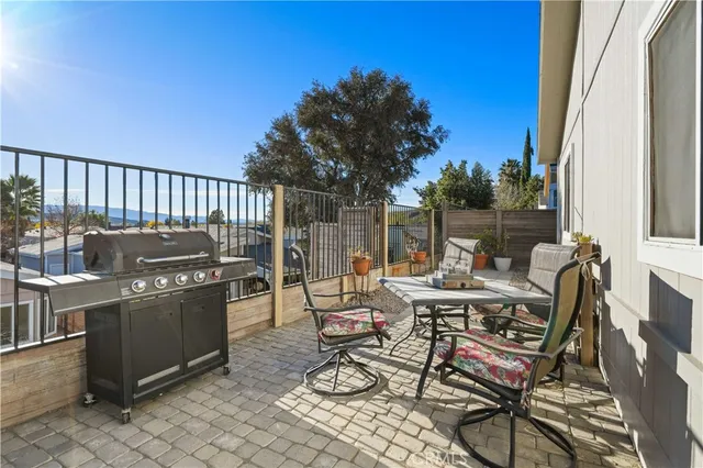 a view of a patio with a dining table and chairs with wooden floor