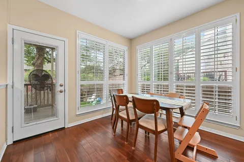 a dining room with furniture and wooden floor