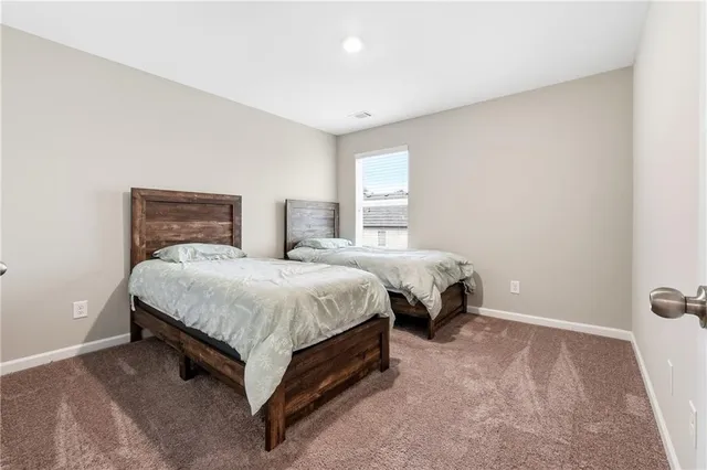 a spacious bedroom with a bed and window