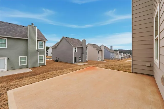 a view of a house with a backyard