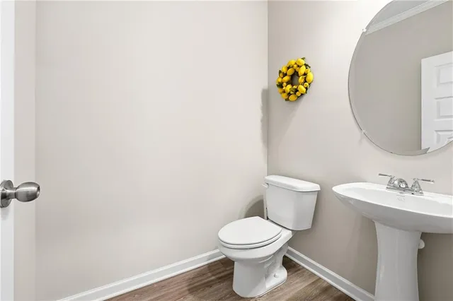 a white toilet sitting next to a bathroom sink
