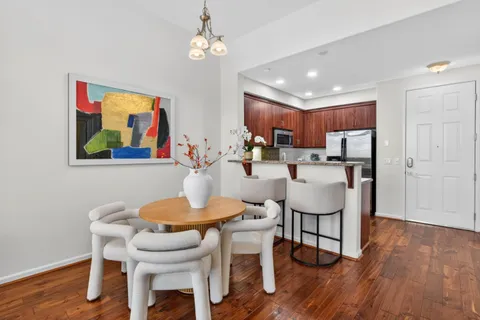 a view of a dining room with furniture wooden floor and chandelier