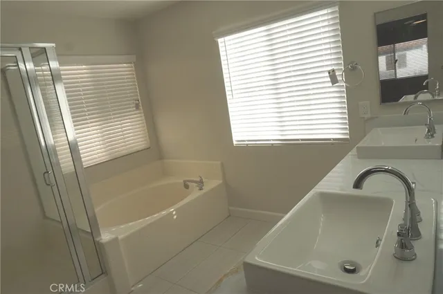a bathroom with a bathtub and a shower