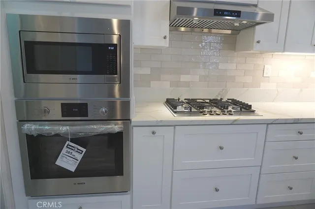 a kitchen with a stove and cabinets