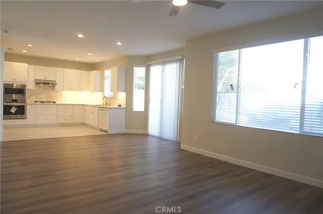 a view of kitchen with wooden floor and electronic appliances