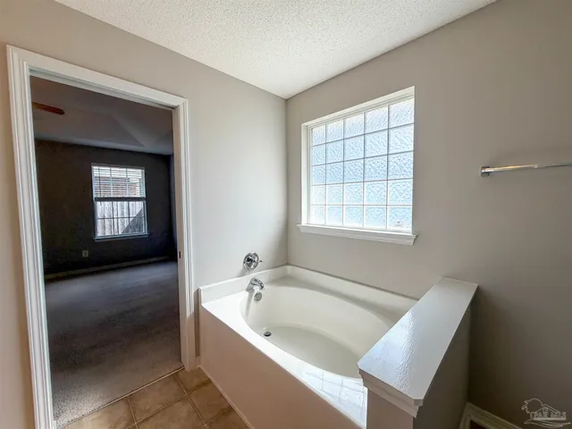 a bathroom with a bathtub and a window