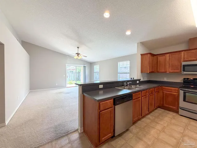 a kitchen with stainless steel appliances granite countertop a stove and a sink