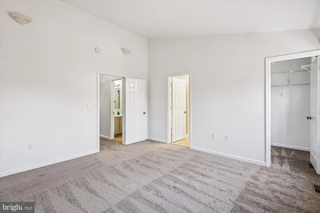 an empty room with windows and closet