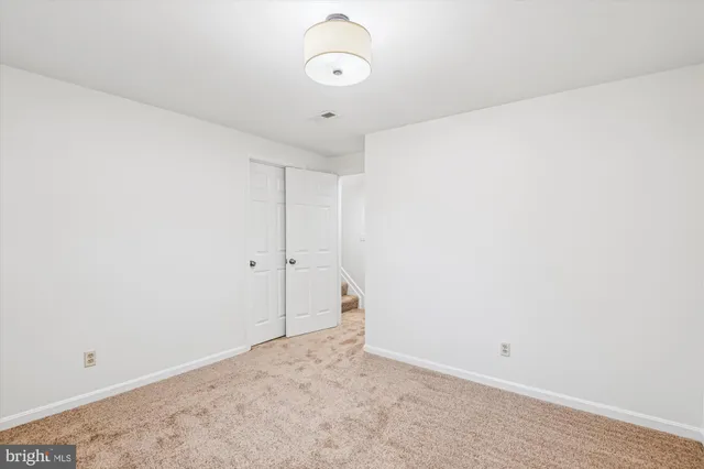 a view of an empty room with glass door