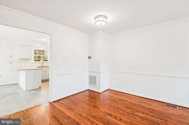 a view of a kitchen with wooden floor and a sink