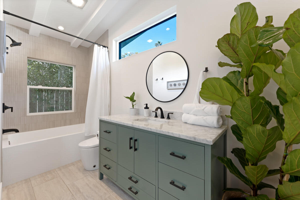 2214 Channing Way Santa Barbara, CA 93109 - Photo 14 of 44 a bathroom with a granite countertop sink and a mirror