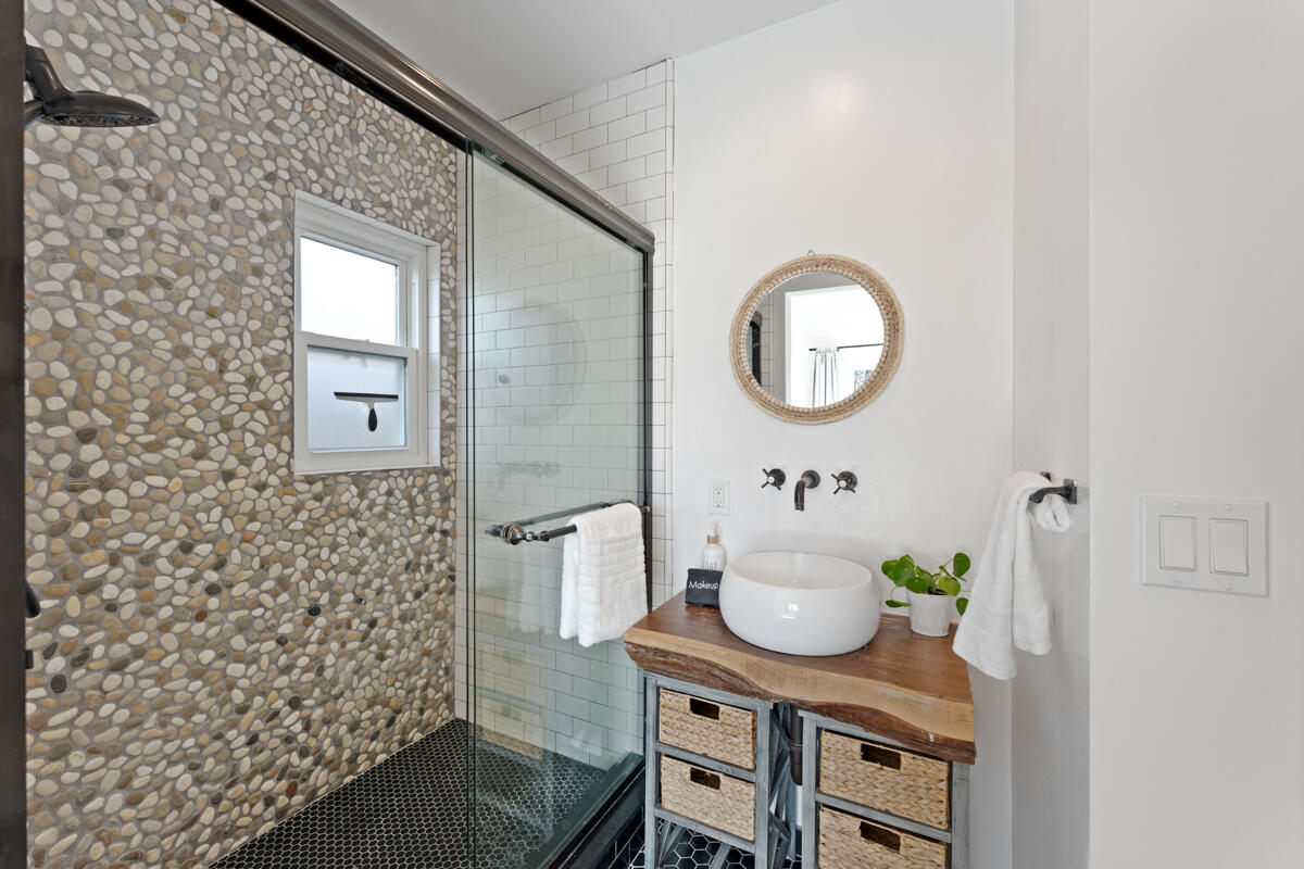 2214 Channing Way Santa Barbara, CA 93109 - Photo 18 of 44 a bathroom with a granite countertop sink a toilet and a mirror