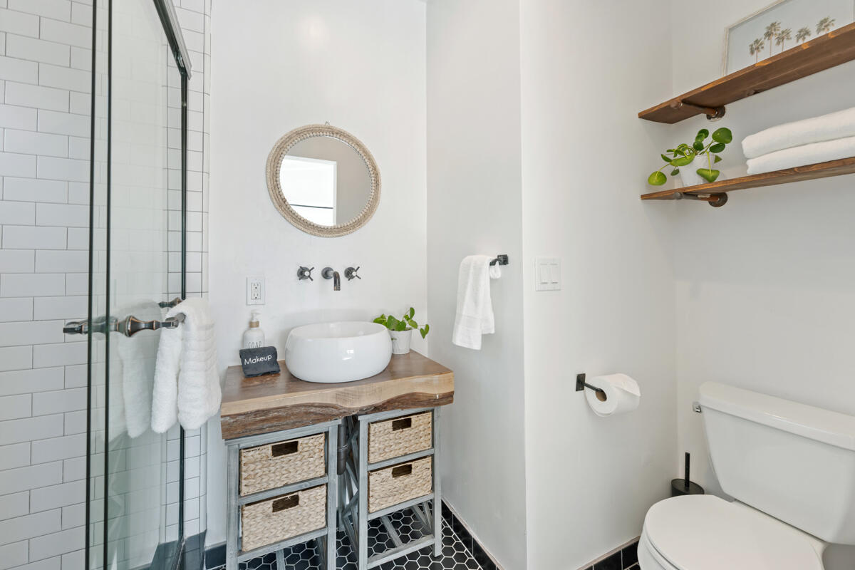 2214 Channing Way Santa Barbara, CA 93109 - Photo 20 of 44 a bathroom with a toilet a sink and a mirror