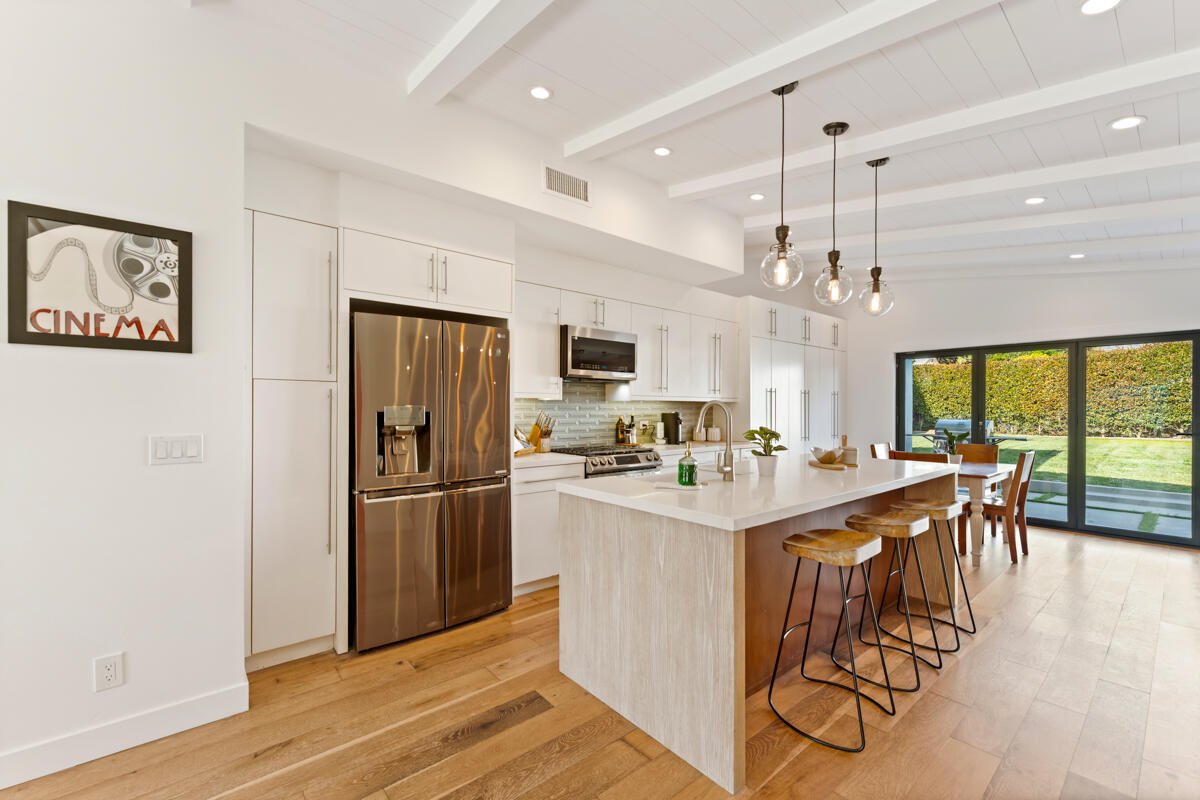 2214 Channing Way Santa Barbara, CA 93109 - Photo 4 of 44 a kitchen with stainless steel appliances granite countertop a refrigerator oven a sink dishwasher and white cabinets with wooden floor