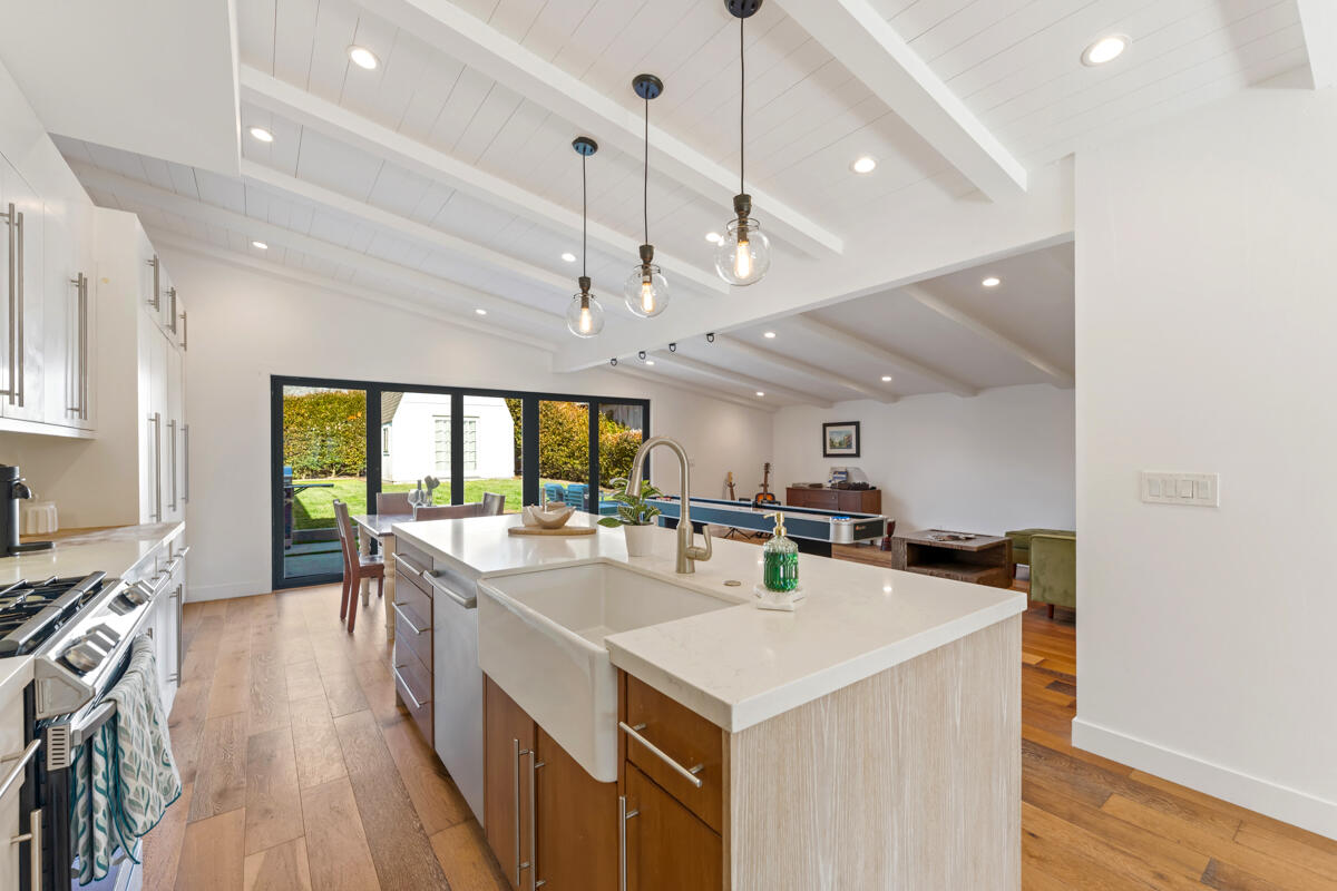 2214 Channing Way Santa Barbara, CA 93109 - Photo 6 of 44 a kitchen with a stove a refrigerator a sink a dining table and chairs with wooden floor