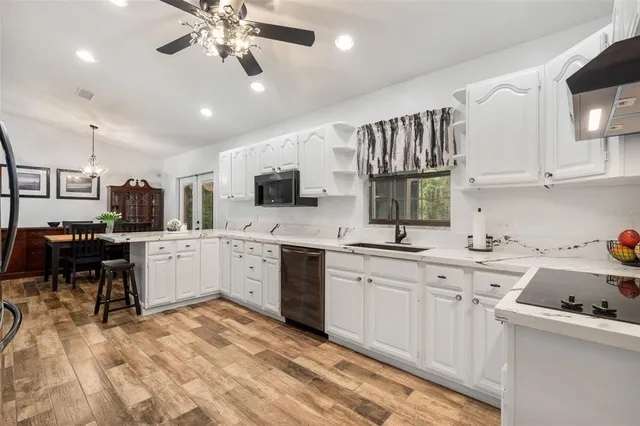 a kitchen with a sink cabinets and window