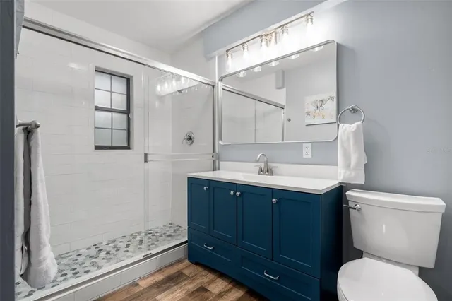 a bathroom with a sink toilet and shower