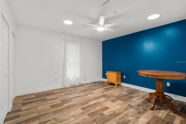 a bedroom with a bed and a chair