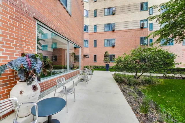 a view of a patio with table and chairs and potted plants