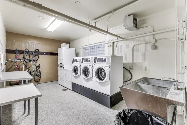 a utility room with kitchen a sink and a stove top oven
