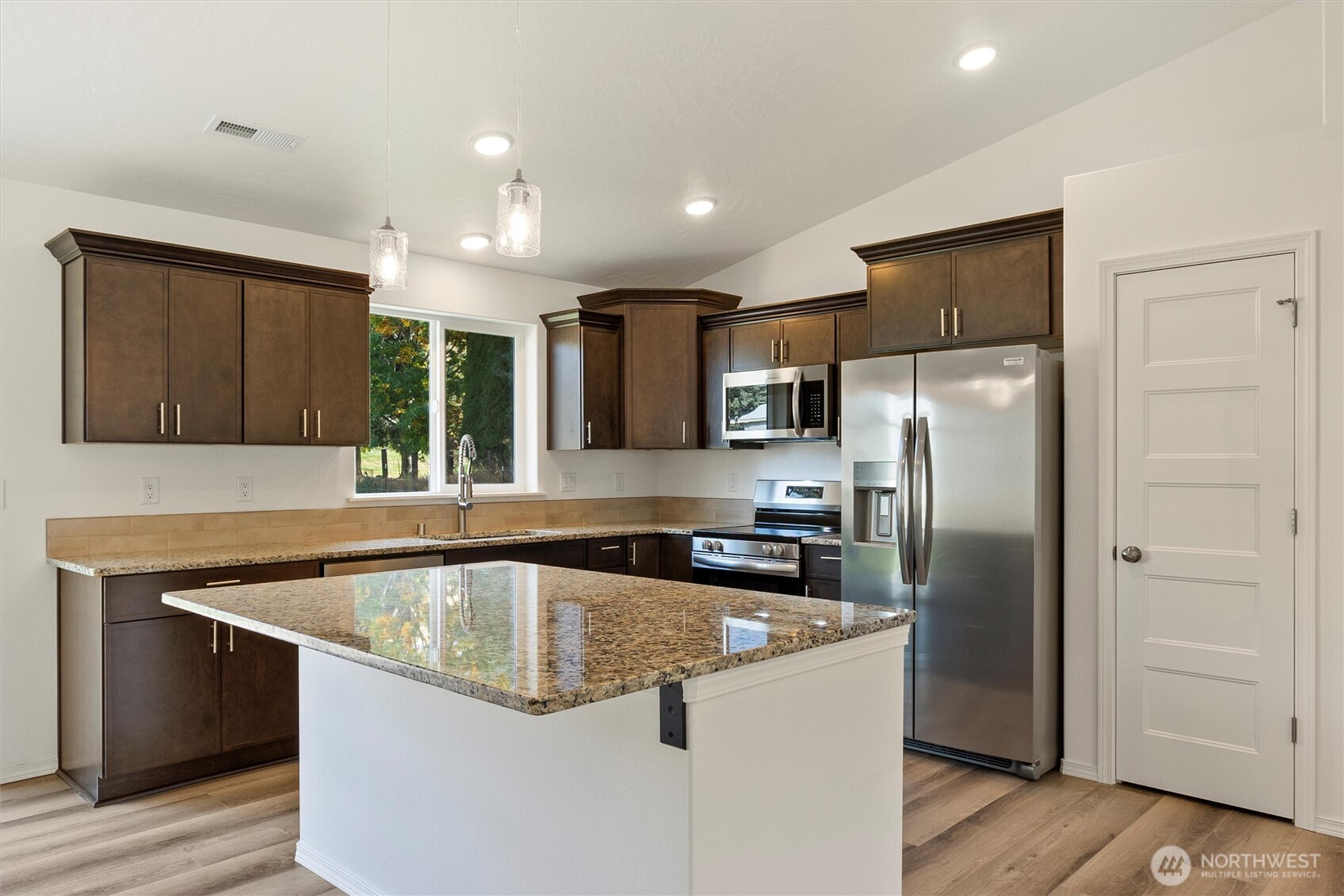 1507 South 5th Street Dayton, WA 99328 - Photo 13 of 35 a kitchen with granite countertop stainless steel appliances a refrigerator a sink and cabinets