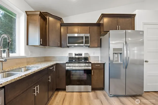 a kitchen with a refrigerator stove and sink